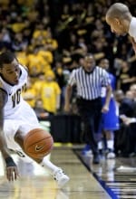TheusSmart Shaka Smart watches on intently as Darius Theus saves a loose ball versus Hofstra last week.